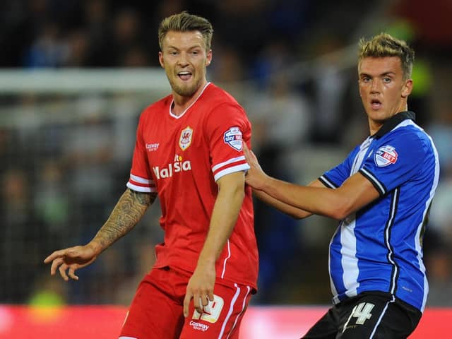 Emyr Huws, who went on to sign for Cardiff, does battle with future Latics player Anthony Pilkington