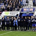 Members of the Latics board, including Lucas Danson, Anthony Cole-Johnson and Brenda Spencer, were pitchside before the game to pay their respects