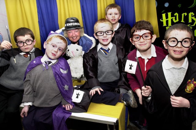 Some young wizards cast their spell on ADC for the Beaver Scouts Wigan District, Joyce Kendrick, during a special Harry Potter night at the Goose Green headquarters of the 16th Wigan Beaver Scouts on Thursday 4th of March 2004.
