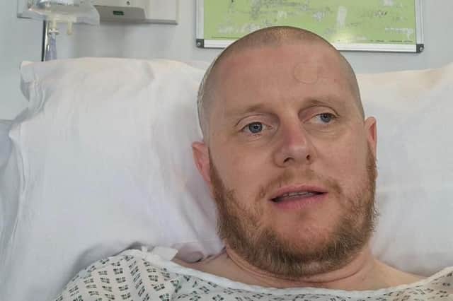 Adam in hospital, after shaving off his hair