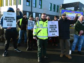 Paramedic Jonny White, centre, with colleagues and supporters at the picket line outside Wigan Community Fire and Ambulance Station