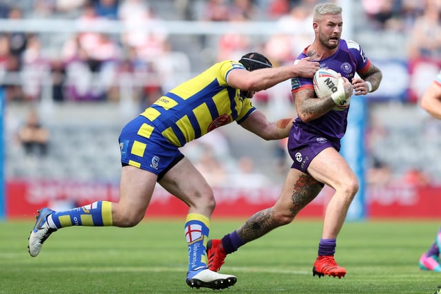 Rugby League - Dacia Magic Weekend 2021 - Wigan v Warrington - St. James's Park, Newcastle, England - Wigan Warriors' Zak Hardaker in action with Warrington Wolves' Chris Hill - Picture by John Clifton/SWpix.com - 05/09/2021 -