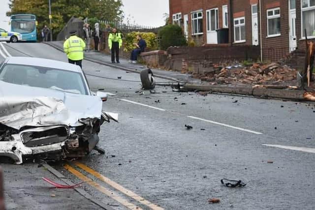 The wrecked car and the damage it caused on Lily Lane
