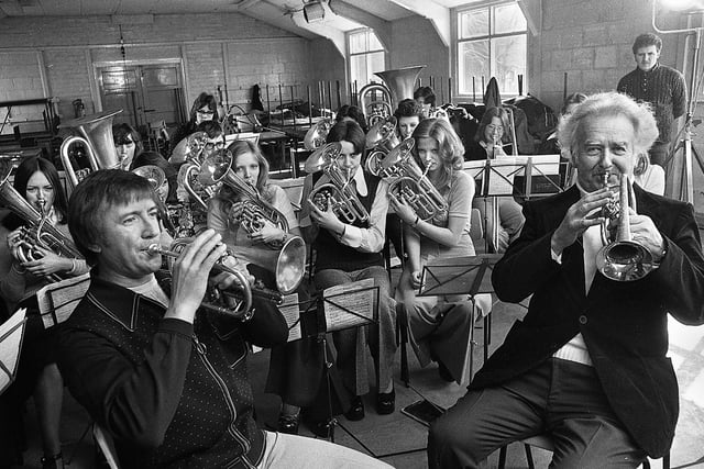 Television entertainer Roy Castle joins bandsman, Harry Mortimer, and Ashton-in-Makerfield Secondary School brass band for a recording of his BBC television show "Roy Castle Beats Time" on Friday 4th of April 1975. .
