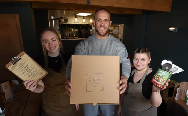 Lee Mossop with staff members, Emily Brown, left, and Megan Walsh, right.