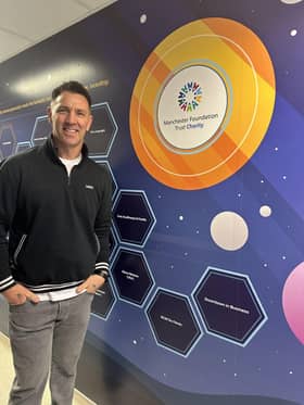 Paul Sculthorpe MBE next to Fundraising Hero plaque