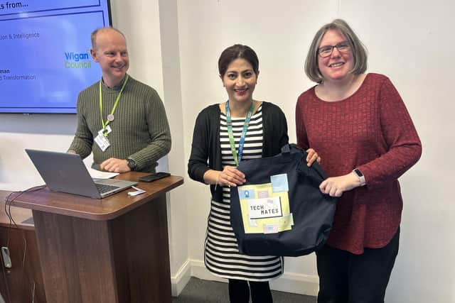 Coun Nazia Rehman presents volunteer Sarah Platt with a TechMates goody bag at a recent Digital Community Partnership celebration event at Wigan Town Hall. Also pictured: Rob Gregory, assistant director for digital transformation and intelligence.