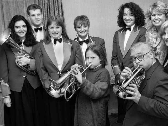 Actor, Edward Woodward, of Callan and Equaliser fame, tunes in with daughter, Emily, before a St. Valentines concert by the Wingates Brass Band at the Georgian House, Blackrod, on Tuesday 14th of February 1995.  Edward was a brass band enthusiast and had heard the Westhoughton based band on CD and so, whilst filming for Granada, took the opportunity to catch a live performance.  The band were also pleased that he accepted their Presidency.  Edward's actress wife, Michelle Dotrice, right, dosen't look too impressed with his efforts but friend Tracy Dawson, widow of comedian, Les, and members of the band reserved judgement.