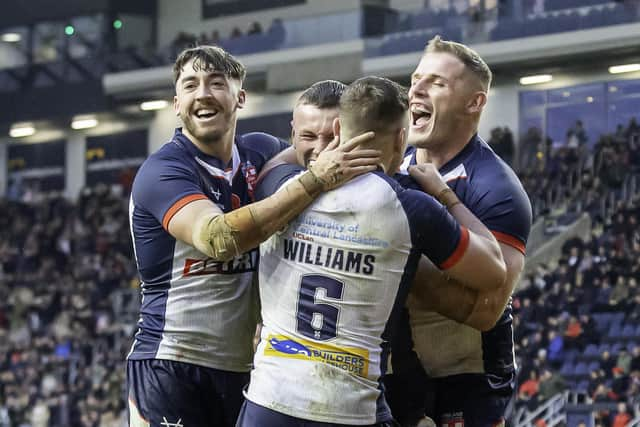 England's Harry Newman (c) is mobbed by Matty Ashton, George Williams and Tom Burgess after scoring a try against Tonga