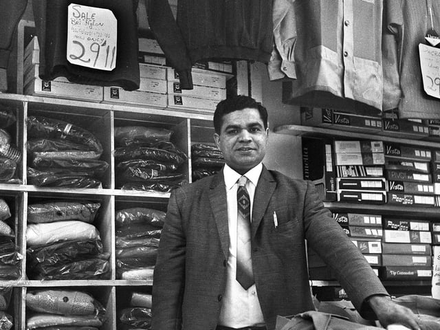 Menswear stall holder Ali Khan in the Old Arcade, Wigan, in the early 1970s.