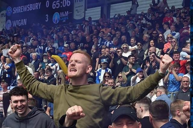 The Latics fans celebrate victory at Shrewsbury