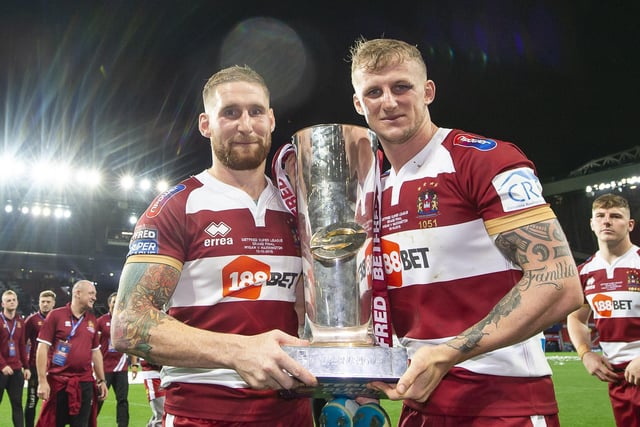 Sam Tomkins and Dom Manfredi hold the Super League trophy wearing the 2018 home kit.