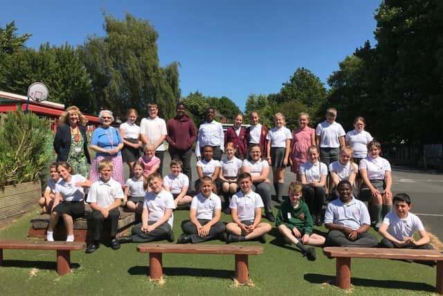 The year six class in the Peace Garden after receiving their badges