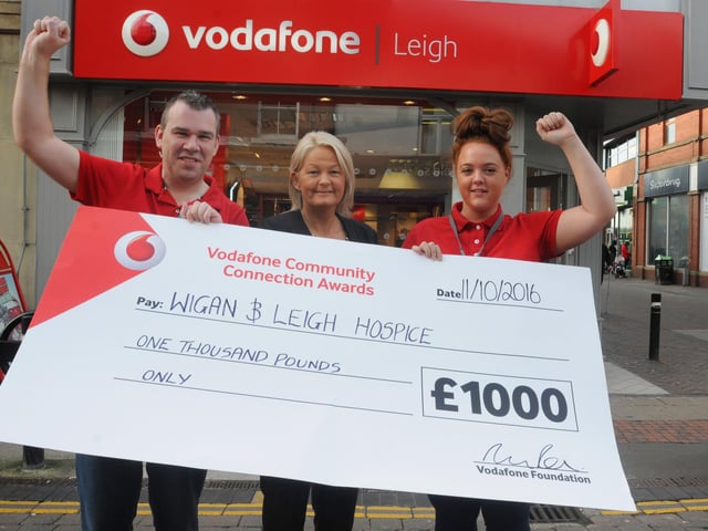 Christine Edwardson, community fund-raiser at Wigan and Leigh Hospice, centre, is delighted to receive a £1,000 check from Vodafone store, Bradshawgate, Leigh, pictured with store manager Paul MacDonald, left, and assistant manager Paige Prescott, right