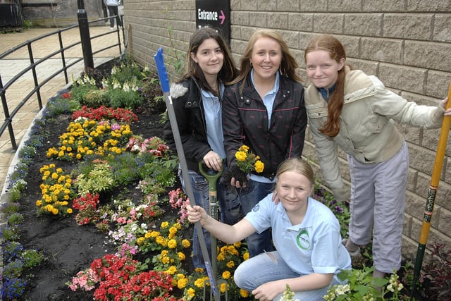 2008 - Students at Rose Bridge High have been helping in the flower beds of Concert Square at Grand Arcade, Wigan. Pictured fromleft, Leasha, Sinead,  Kirsty (front) and Rachel.