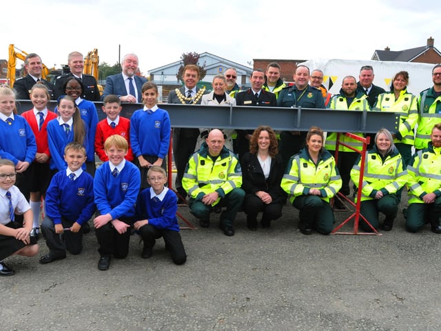 Members of Greater Manchester Fire and Rescue Service, North West Amublance Service, the Mayor of Wigan and children from nearby St Mark's CE Primary School, attended a ceremony to sign the last piece of steel to form the structure of the emergency services HQ on Robin Park Road