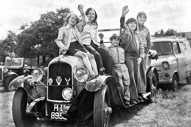 Local youngsters astride one of the old vehicles at a vintage rally on the vicarage field, Warrington Road, Goose Green, in May 1975.