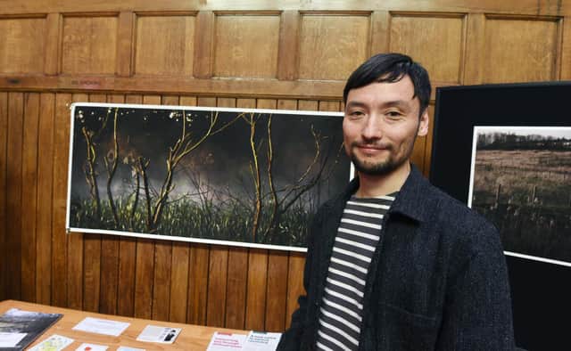 Artist Mario Popham with his work on display