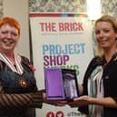 The Queen's Award for Voluntary Service was bestowed on The Brick homelessness charity in Wigan two years ago.  Melanie Bryan OBE, deputy lieutenant of Greater Manchester, is seen here presenting it to volunteer co-ordinator Emma Shaw