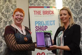 The Queen's Award for Voluntary Service was bestowed on The Brick homelessness charity in Wigan two years ago.  Melanie Bryan OBE, deputy lieutenant of Greater Manchester, is seen here presenting it to volunteer co-ordinator Emma Shaw