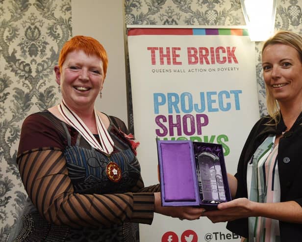 The Queen's Award for Voluntary Service was bestowed on The Brick homelessness charity in Wigan two years ago.  Melanie Bryan OBE, deputy lieutenant of Greater Manchester, is seen here presenting it to volunteer co-ordinator Emma Shaw