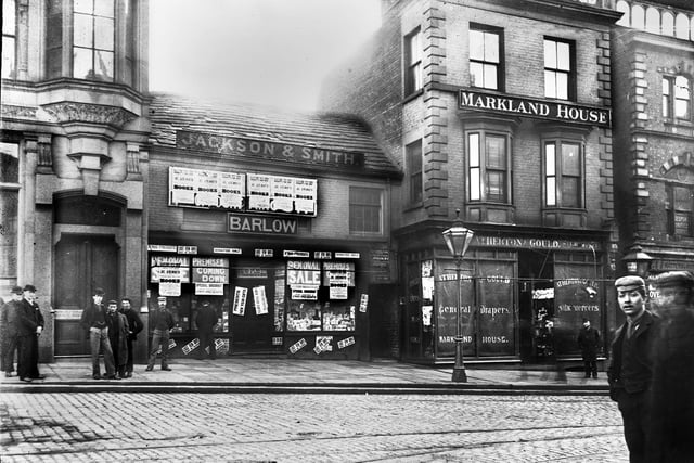 Market Place in 1898 and a closing down sale at Barlow's book shop prior to demolition of the premises and Atherton and Gould next door to make way for the building of Library Street. The building on the left is now The Moon Under Water pub.

