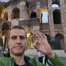 Chris Woodward does the Andy's Man Club hand gesture outside the Coliseum in Rome