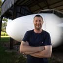 Steve Jones with his incredible Boeing 737 cockpit and cabin in his Dutch barn