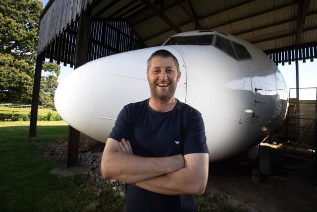 Steve Jones with his incredible Boeing 737 cockpit and cabin in his Dutch barn