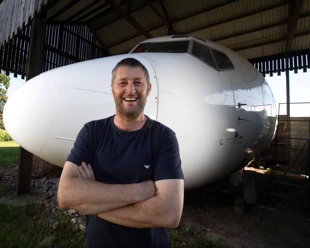 Steve Jones with his incredible Boeing 737 cockpit and cabin in his Dutch barn
