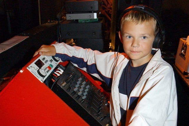 Eleven year old DJ, Tom Midgley at the decks in Maximes Nightclub.
