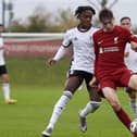 Luke Chambers in action for Liverpool, taking on Martial Godo in Fulham colours