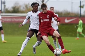 Luke Chambers in action for Liverpool, taking on Martial Godo in Fulham colours