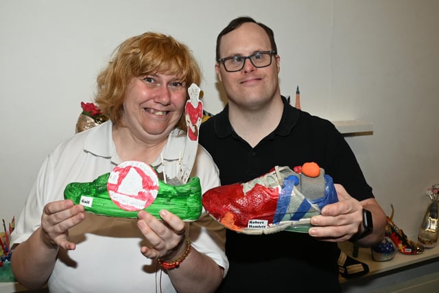 from left, Gail Taylor and Robert Hamlett with their shoe designs.