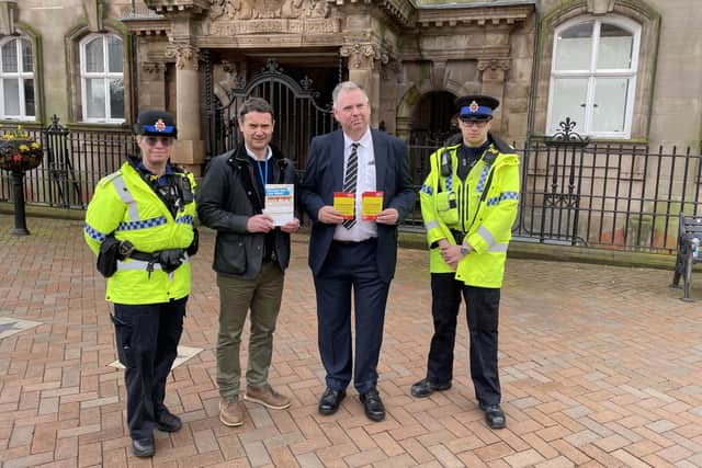 Coun Kevin Anderson with representatives from Wigan Council Trading Standards and Greater Manchester Police.
