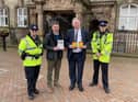 Coun Kevin Anderson with representatives from Wigan Council Trading Standards and Greater Manchester Police.