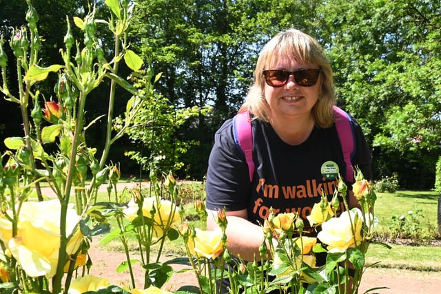 Walkers admire the rose garden in Mesnes Park, Wigan.