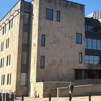 A racist Wigan man admits to a violent attack and hurling abuse