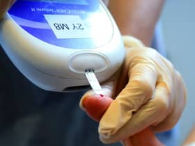 A nurse tests a patient with diabetes
