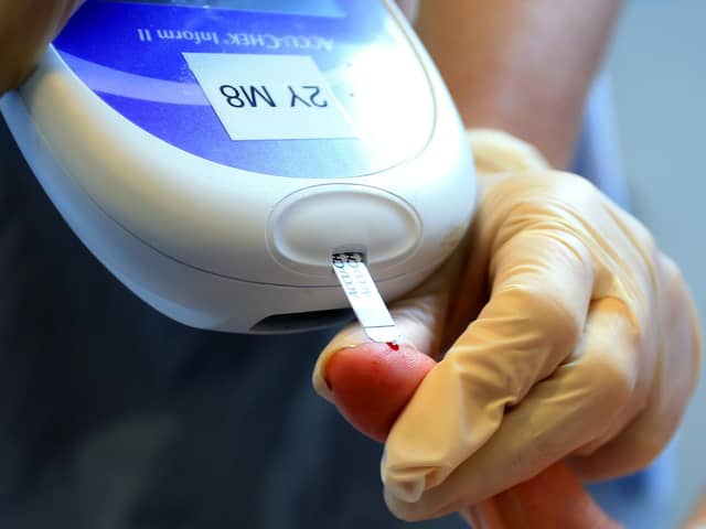 A nurse tests a patient with diabetes