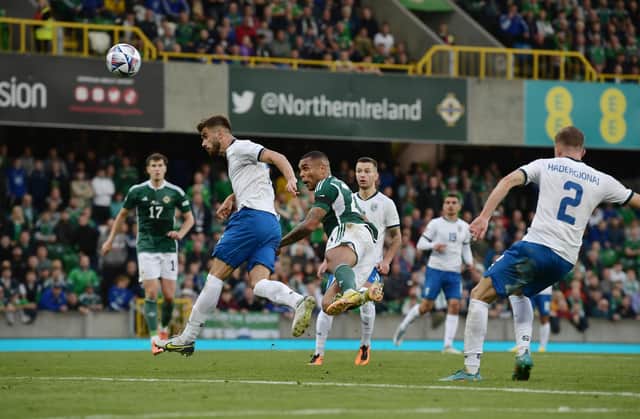 Josh Magennis heads home Northern Ireland's late winner against Kosovo