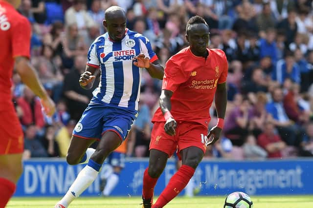 Sanmi Odelusi in action for Latics during a pre-season friendly against Liverpool in 2016