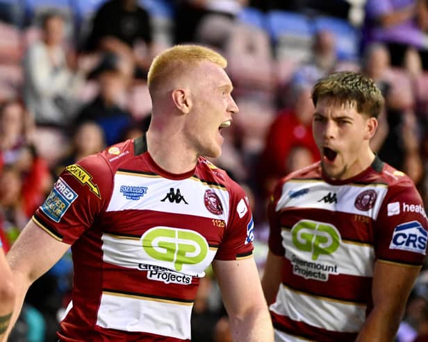 Zach Eckersley (left) celebrates scoring a try with Wigan Warriors teammate Jacob Douglas (right)