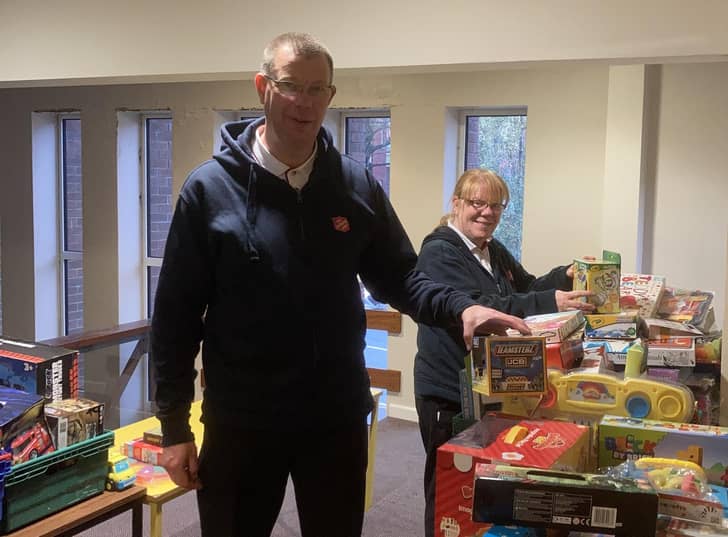 Majors Mark and Alison Lewis receiving gifts for The Salvation Army to redistribute to children at Christmas