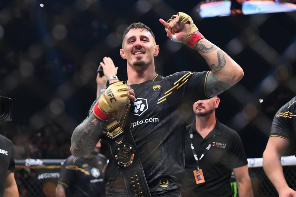 Tom Aspinall celebrates in the octagon after his quickfire stopping of Curtis Blaydes