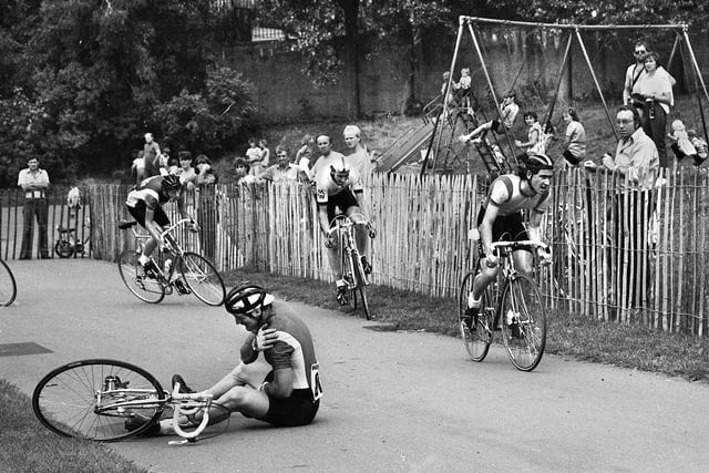 A spilled rider clutches his shoulder duing the cycle racing in Mesnes Park on Sunday 2nd of September 1984.