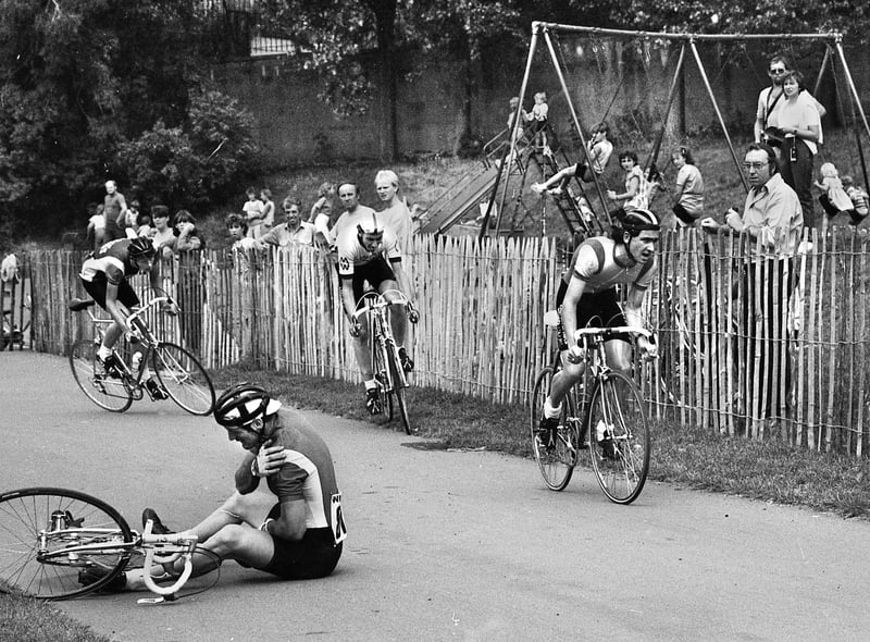 A spilled rider clutches his shoulder duing the cycle racing in Mesnes Park on Sunday 2nd of September 1984.