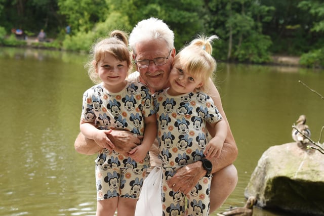 Cliff McSorley with grandchilden Skye, three, left, and Daisy, two, right, have fun in the sun at Three Sisters park, Ashton-in-Makerfield.