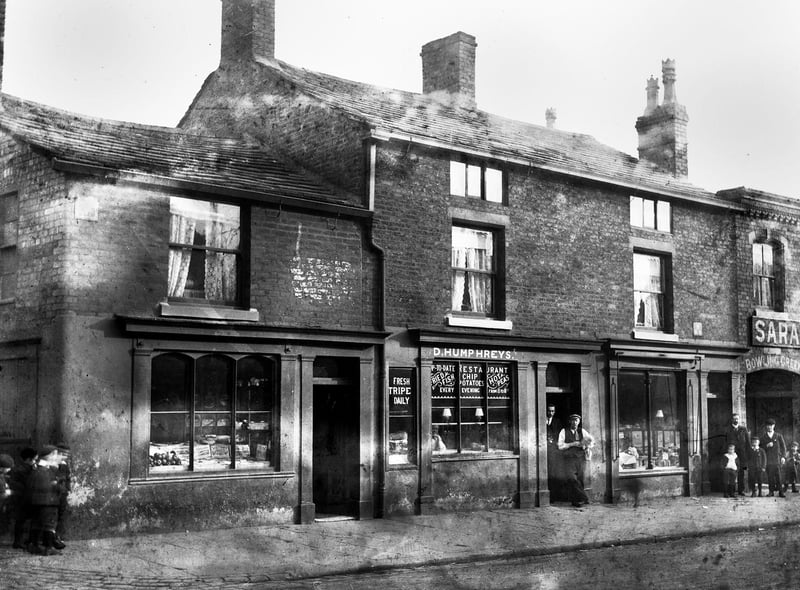 D. Humphreys fish and chip restaurant and the Saracen's Head pub on Wigan Lane around 1900.