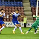 Curtis Tilt heads home Latics' late winner against Blackpool
